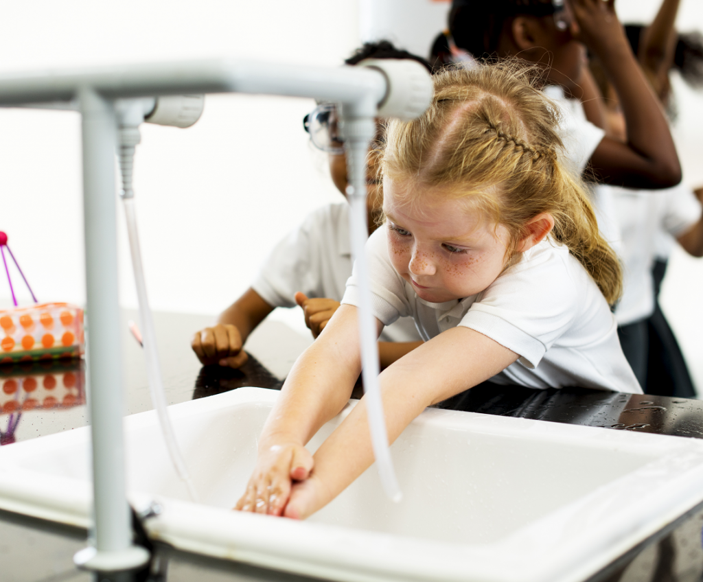 Young girl washing hands