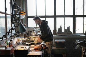 Male master working with metal tools in garage